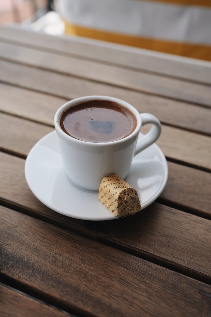 Close-up of a Cup of Coffee and a Biscuit